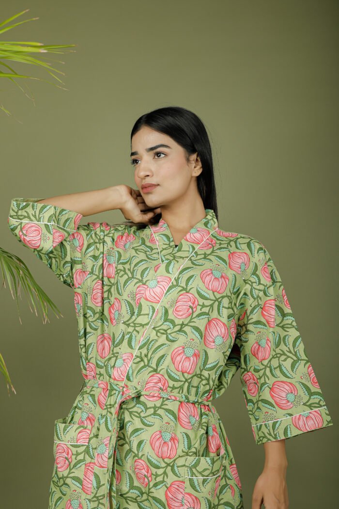 model wearing floral print green color kimono dress on olive green background