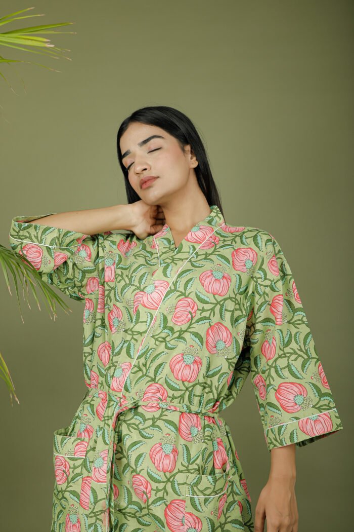 model wearing floral print green color kimono dress on olive green background