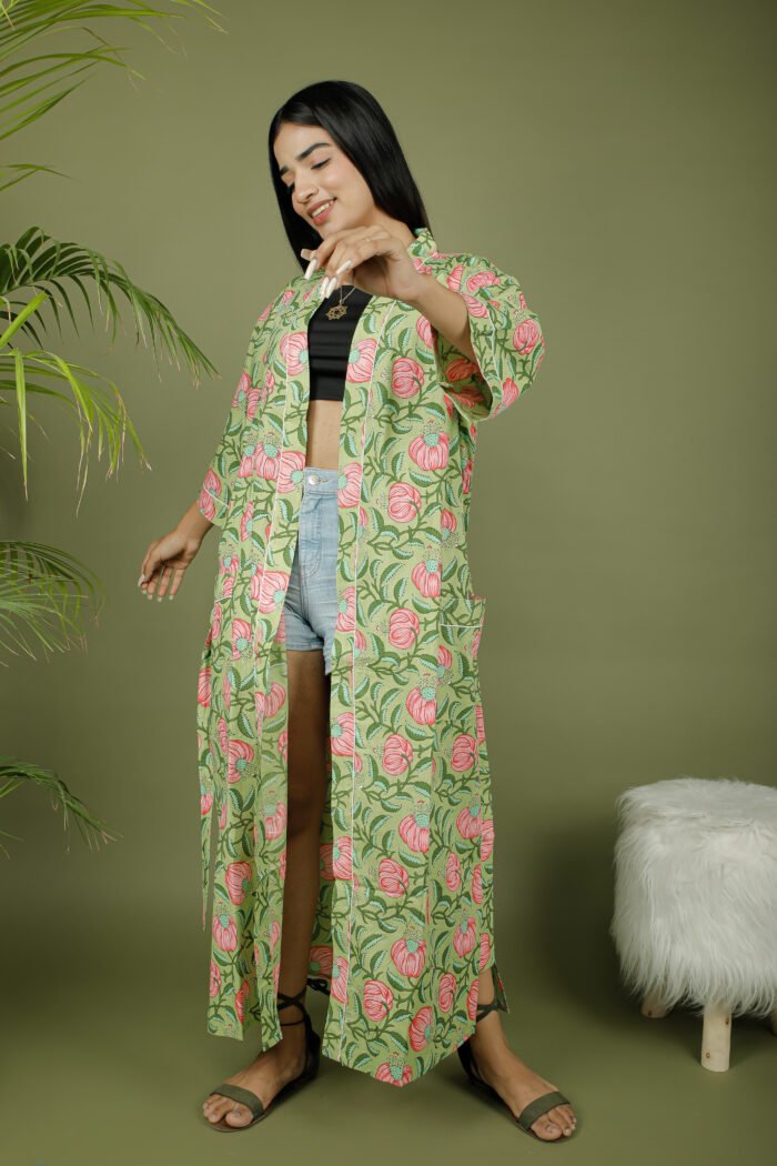 model wearing floral print green color kimono dress on olive green background