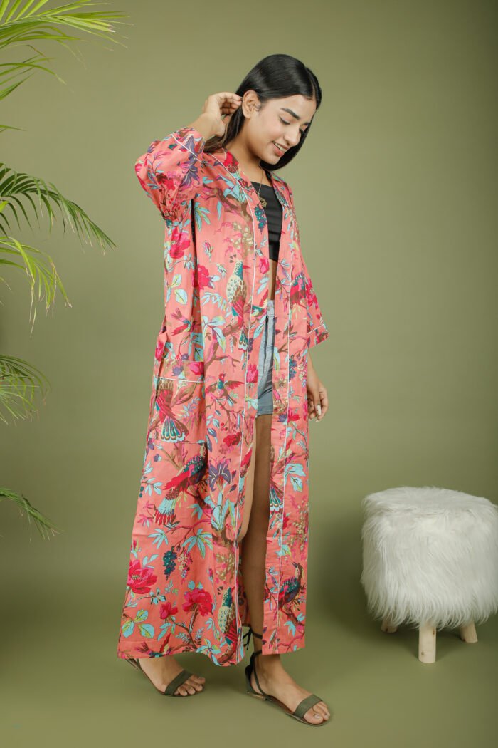 model wearing floral print pink color kimono sleeves dress on olive green background