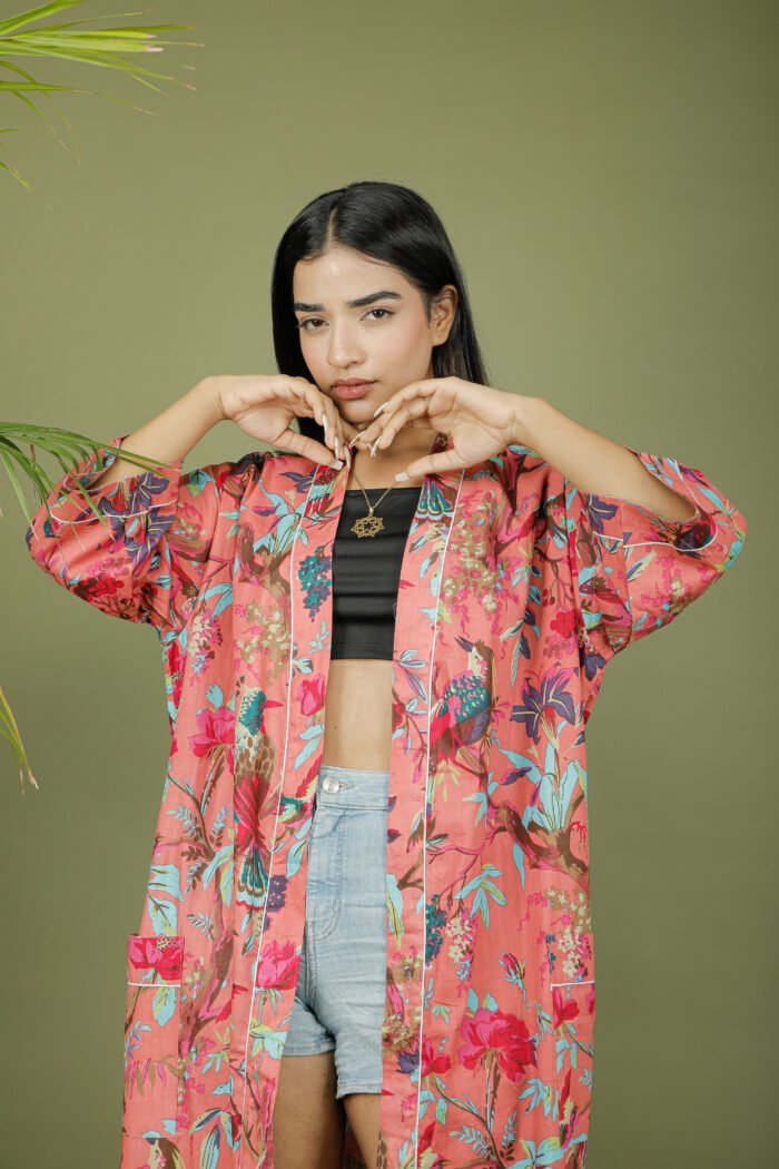 model wearing floral print pink color kimono sleeves dress on olive green background