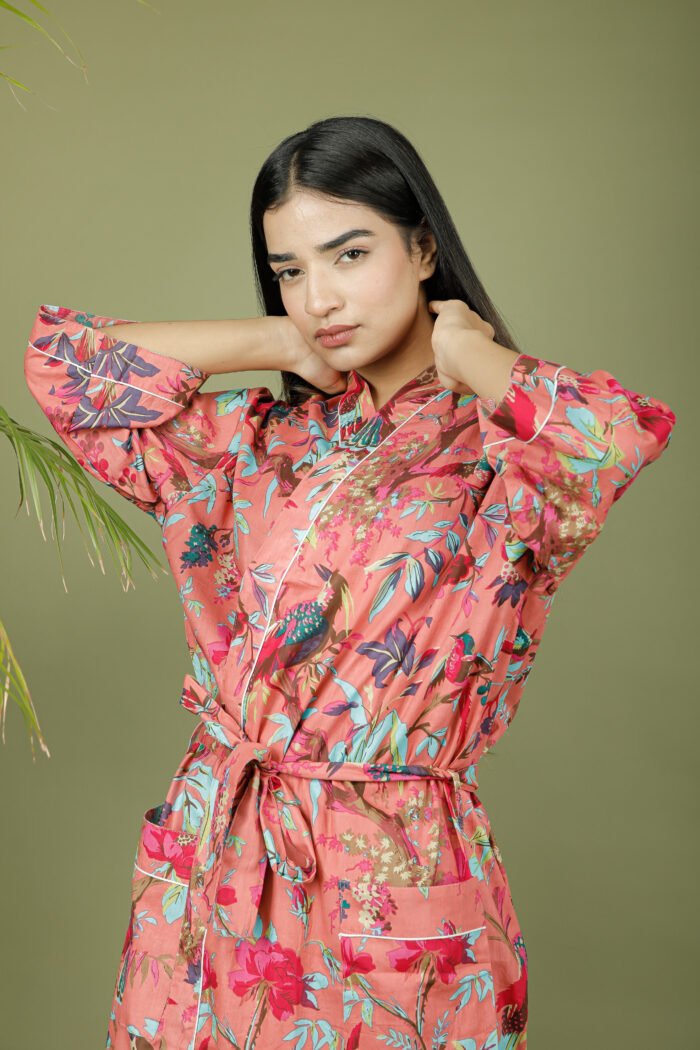 model wearing floral print pink color kimono sleeves dress on olive green background