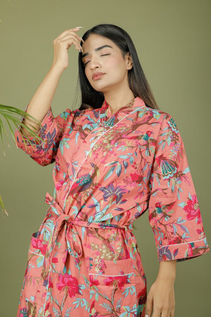 model wearing floral print pink color kimono sleeves dress on olive green background