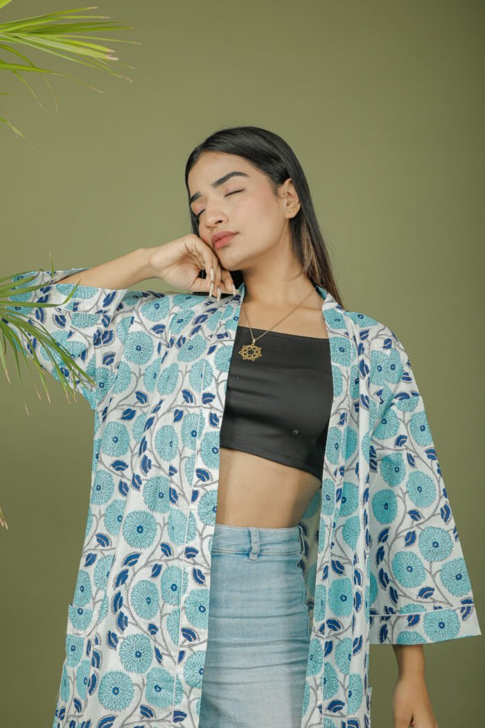 model wearing floral print sky blue color kimono shrug on olive green background