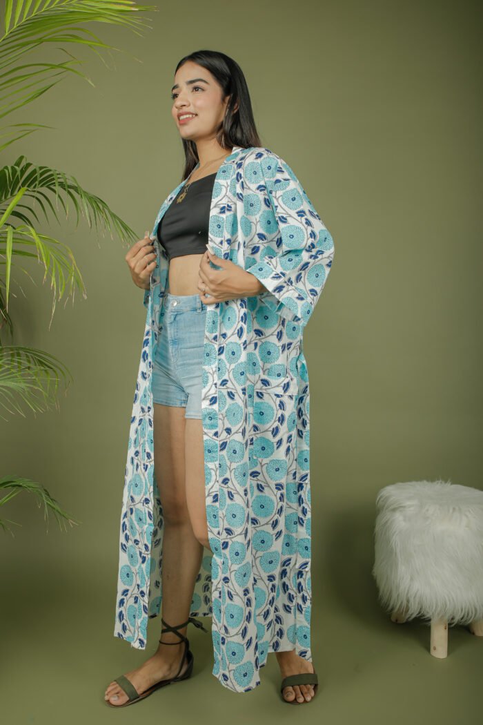 model wearing floral print sky blue color kimono shrug on olive green background