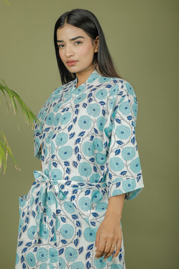 model wearing floral print sky blue color kimono shrug on olive green background