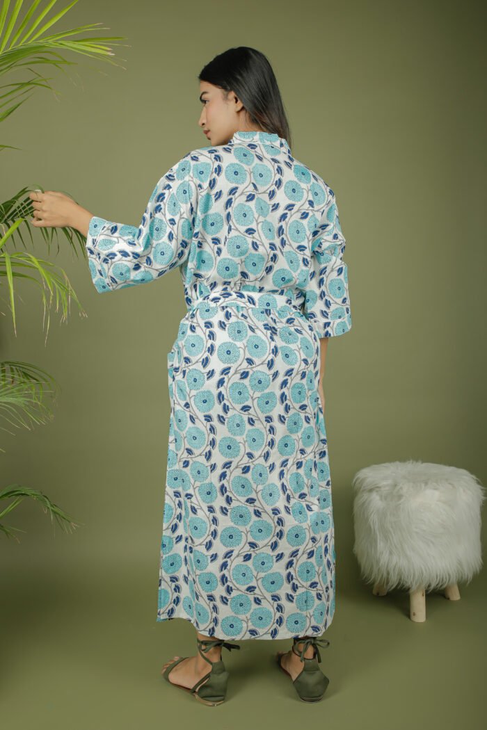 model wearing floral print sky blue color kimono shrug on olive green background