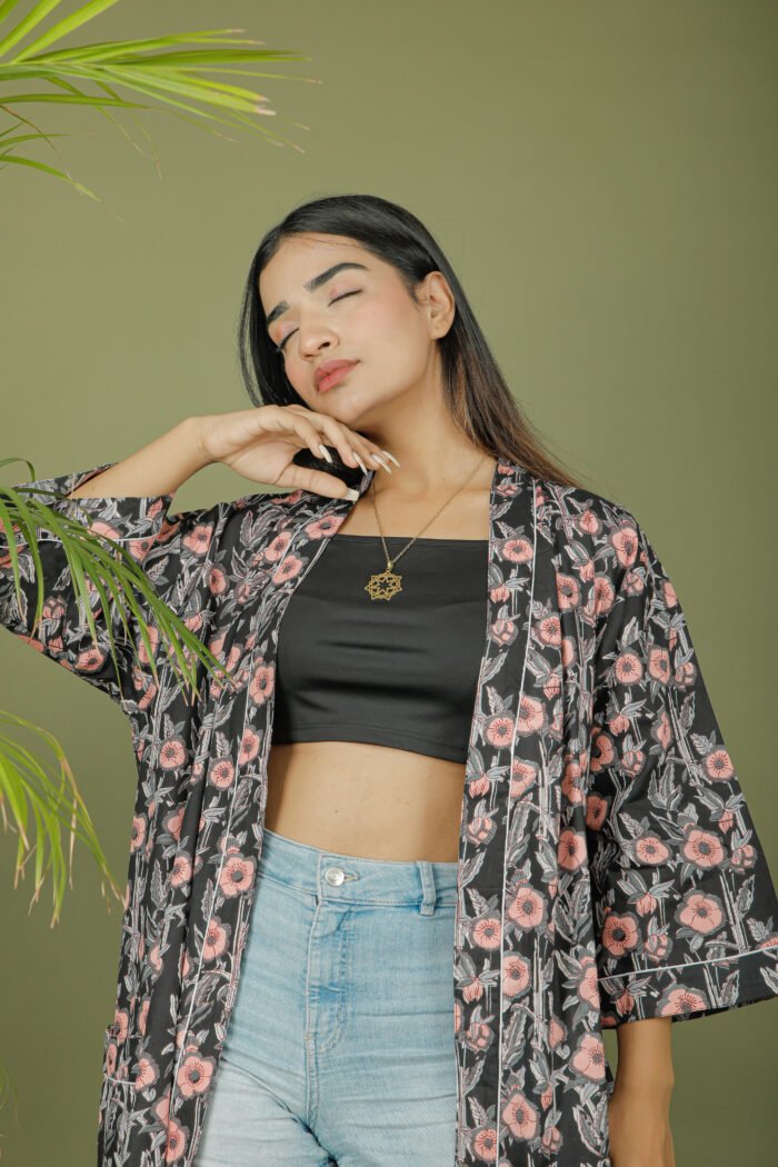 model wearing floral print black color kimono robe on olive green background