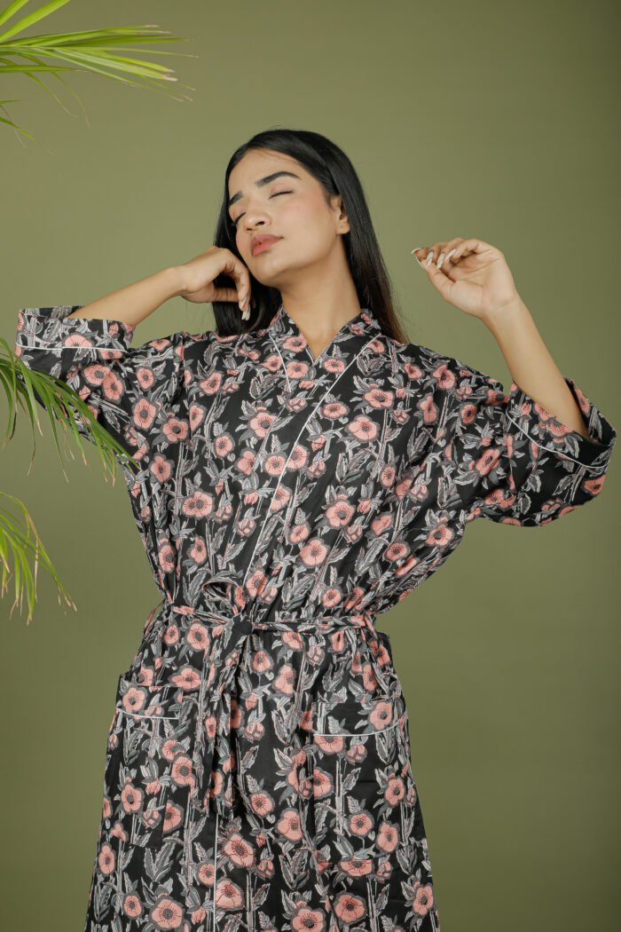 model wearing floral print black color kimono robe on olive green background