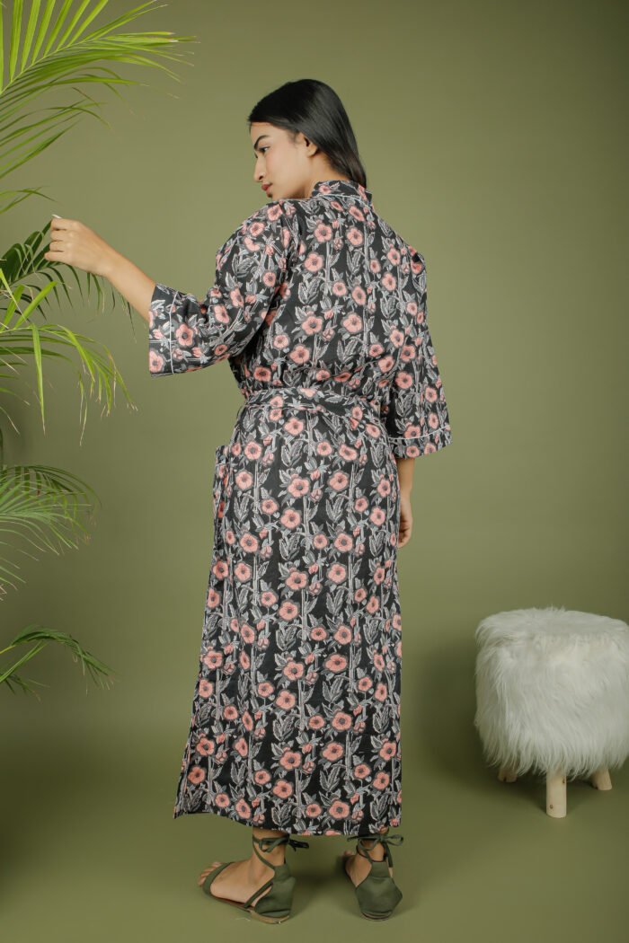 model wearing floral print black color kimono robe on olive green background